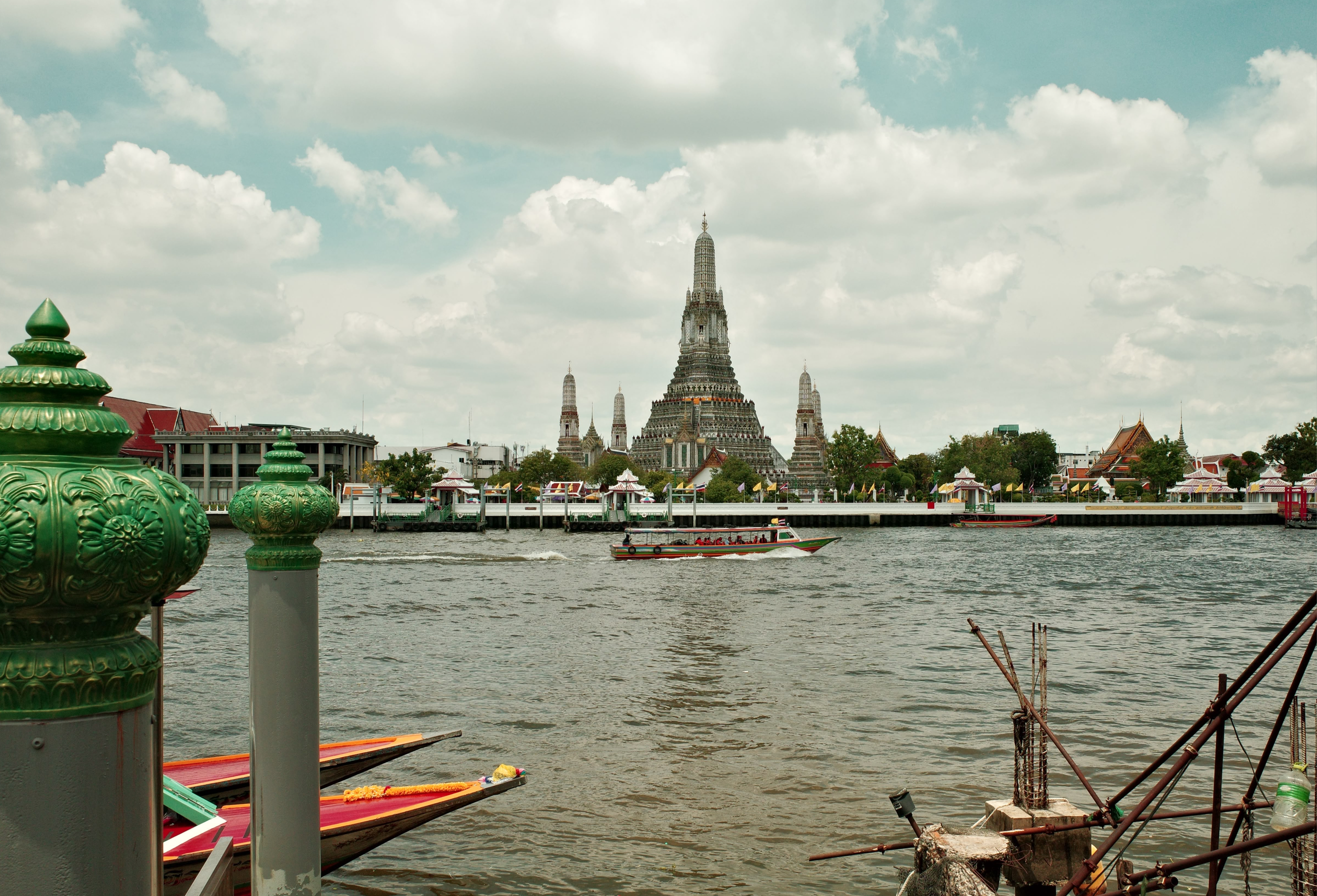 Thailand review view of a boat and a temple in the background